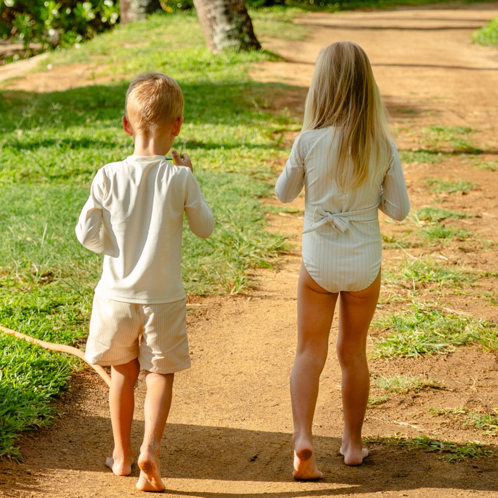 kids wearing sun safe swimwear in a tropical setting kids wearing sun safe swimwear in a tropical setting