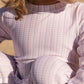 close up of print patter in lavender and peach stripes of full-coverage upf50+ mikou swimsuit