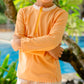 Close up of MIKOU orange rash guard