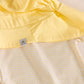 Flat lay of Sunny Yellow sun hat in UPF50+ fabric matching with MIKOU lemon stars print pattern. | MIKOU