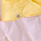 Flat lay of Sunny Yellow sun hat in UPF50+ fabric matching with MIKOU pink print pattern. | MIKOU