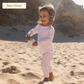 A baby wearing a full coverage MIKOU UPF50+ baby girl UV swimsuit.