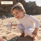 A baby wearing a full coverage MIKOU UPF50+ baby boy UV swimsuit.