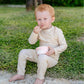 A baby wearing a full coverage MIKOU UPF50+ baby boy UV swimsuit.